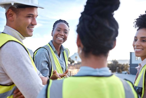 people in hi-vis smilling and laughing. 